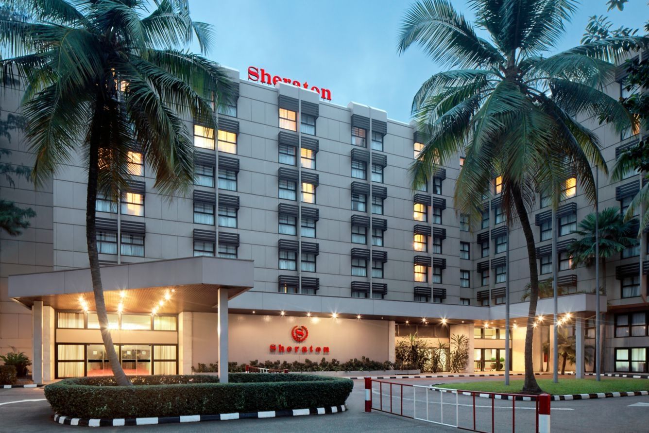 The entrance and facade of Sheraton Lagos Hotel, Ikeja, at dusk